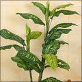 Fake dieffenbachia plant for home decor placed in a decorative pot