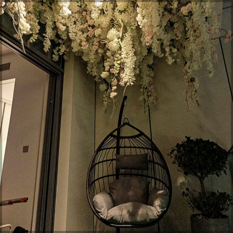 Hanging artificial flowers from ceiling