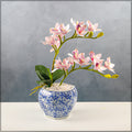 Faux orchids in traditional Chinese vase
